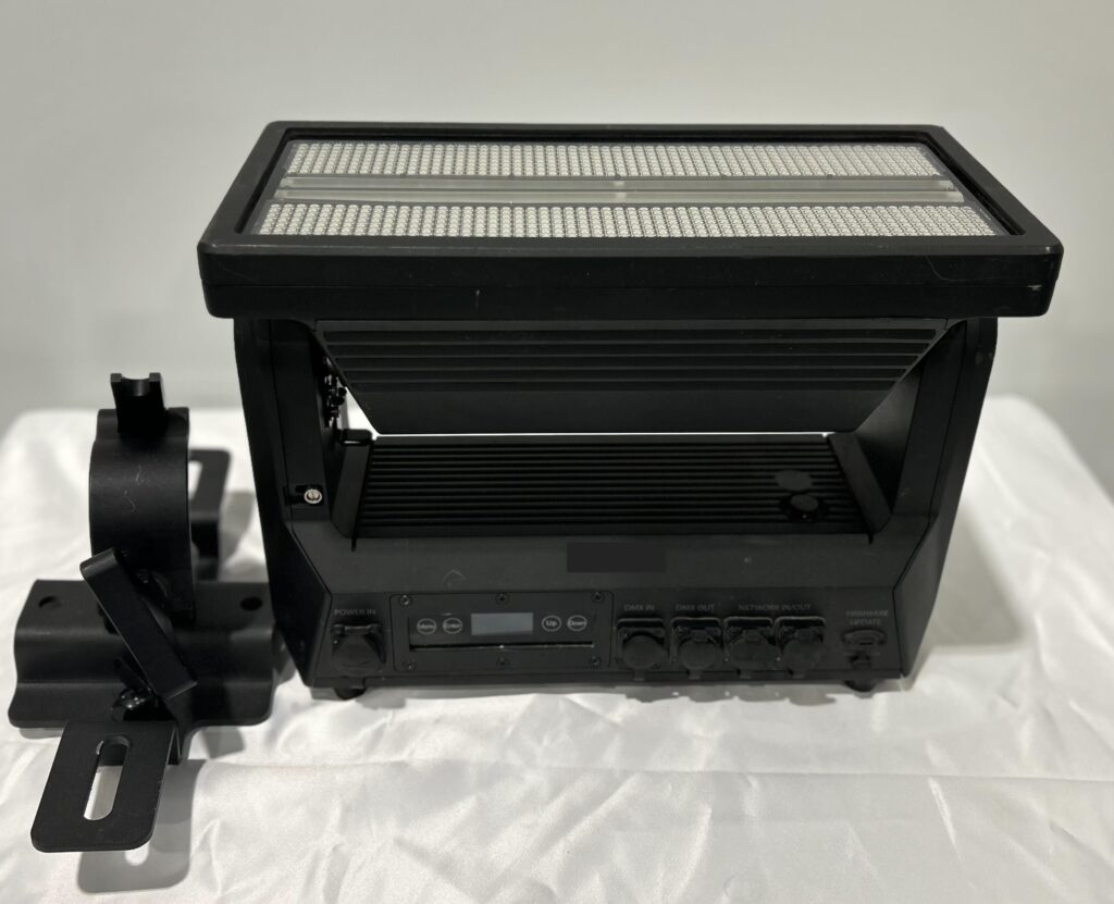 Stage light with control panel and mounting accessories.