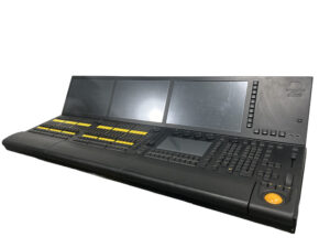 Audio mixing console with multiple screens and controls.