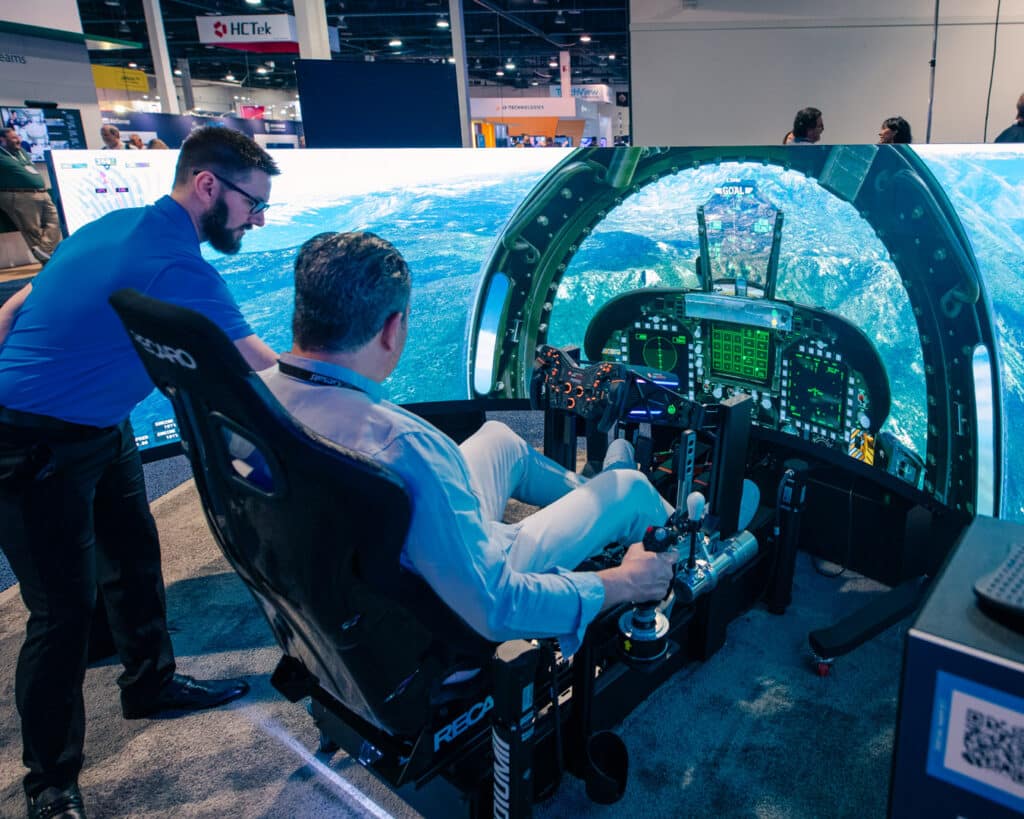 Person using a flight simulator with an ocean scene.