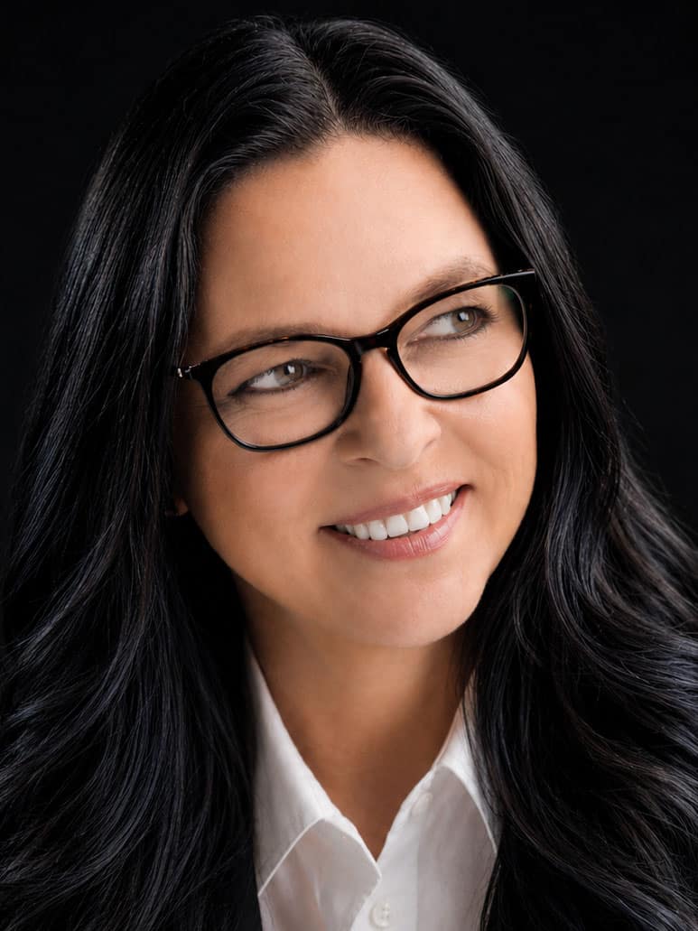 Elite Multimedia team member in glasses and white shirt, corporate event production leadership headshot