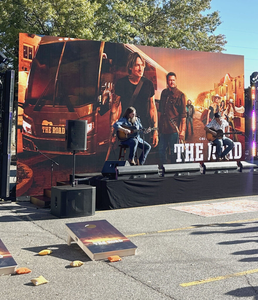 Outdoor stage with large LED backdrop for live performance at promotional event
